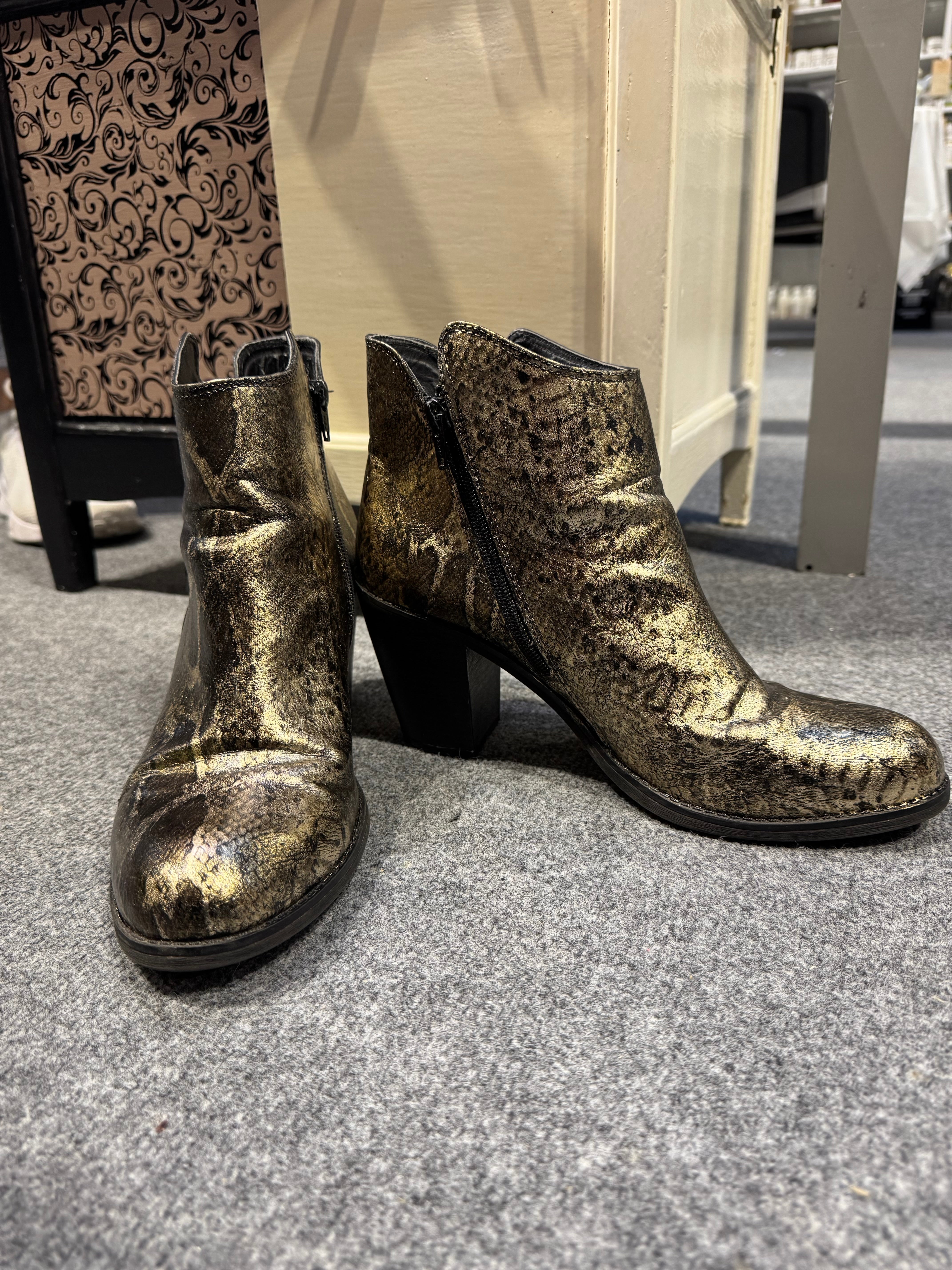 A pair of boots covered with a foil 