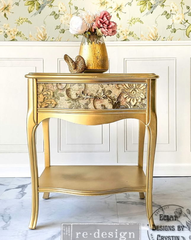 Gold side table with decorative items against a floral wallpapered wall Redesign With Prima Chapelle royale