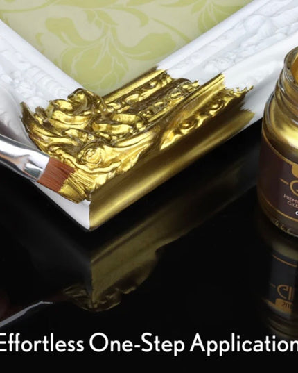Gold paint being applied with a brush to a decorative item, next to a jar of gold paint.
